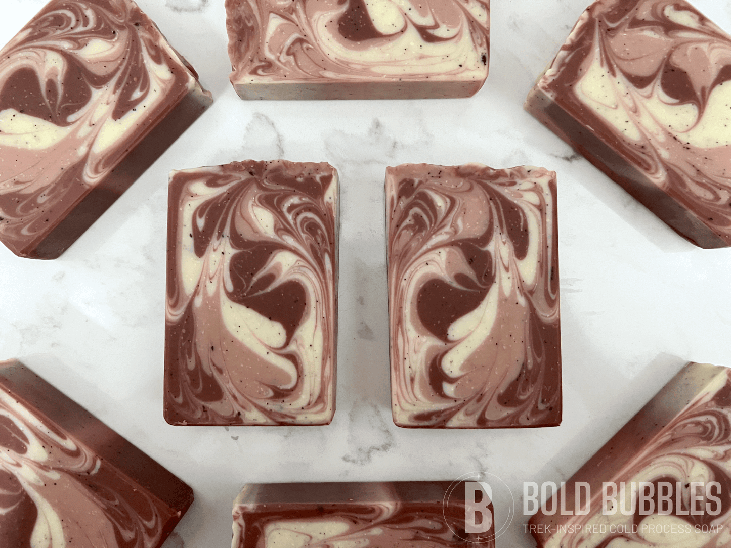 Bars of coffee soap with various shades of brown and cream-colored swirls. They smell like a cafe latte, and they are inspired by Captain Janeway's obsession with coffee on Star Trek: Voyager and Star Trek: Prodigy.