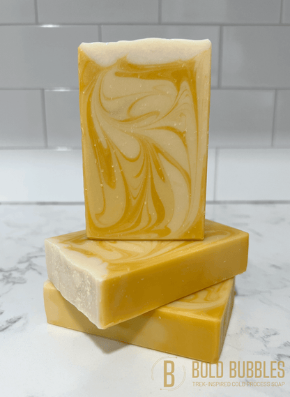 A bar of soap with swirls of varying shades of white and yellow, and a glittery white top. The scent and design was inspired by Bajoran ale, as seen on Star Trek: Deep Space Nine.