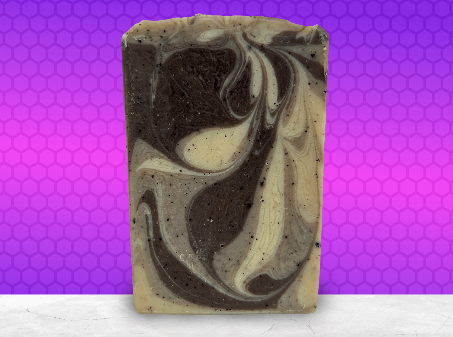A bar of coffee soap with various shades of brown and cream-colored swirls. It smells like a cafe latte, and it is inspired by Captain Janeway's obsession with coffee on Star Trek: Voyager and Star Trek: Prodigy.