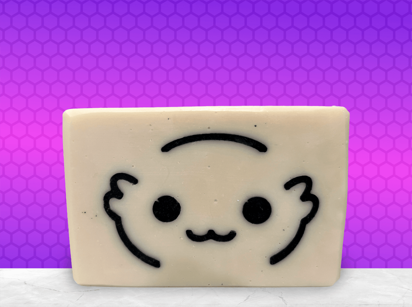 A white bar of soap with the outlines of a cute creature's face called a Moopsy in black. The design was inspired by the adorable but deadly creature from Star Trek: Lower Decks. This soap comes in a variety of scents.