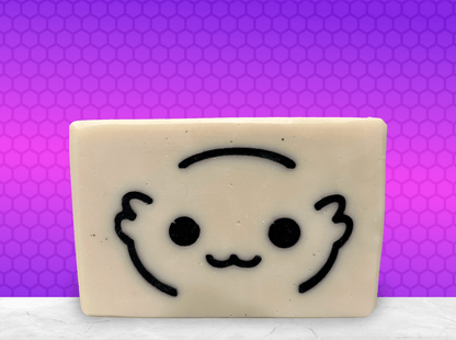 A white bar of soap with the outlines of a cute creature's face called a Moopsy in black. The design was inspired by the adorable but deadly creature from Star Trek: Lower Decks. This soap comes in a variety of scents.