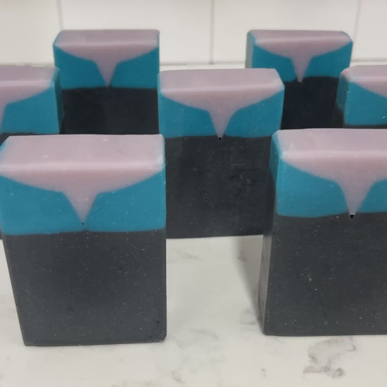 Bars of black, blue, and purplish-grey soap inspired by the look of the uniform worn by Jadzia Dax in the earlier seasons of Star Trek: Deep Space Nine. The scent is cucumber melon.