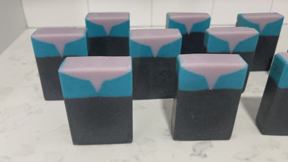 Bars of black, blue, and purplish-grey soap inspired by the look of the uniform worn by Jadzia Dax in the earlier seasons of Star Trek: Deep Space Nine. The scent is cucumber melon.