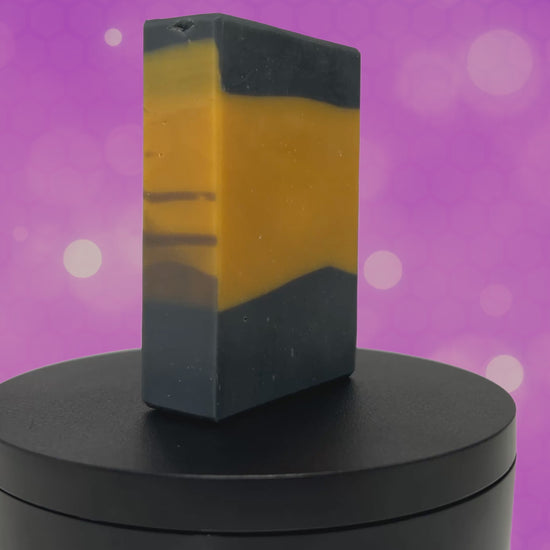 A gold and black bar of soap in the design of the famous TNG-style uniform. The scent is lilac, in honor of Worf.