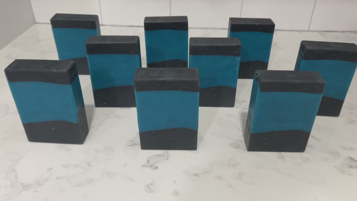 Bars of blue and black soap inspired by the iconic uniforms worn on Star Trek: The Next Generation. The scent is mint frosting, AKA spearmint, in honor of the time Troi became a cellular peptide cake with mint frosting.