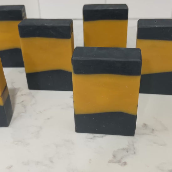 Gold and black bars of soap in the design of the famous TNG-style uniform. The scent is lilac, in honor of Worf.