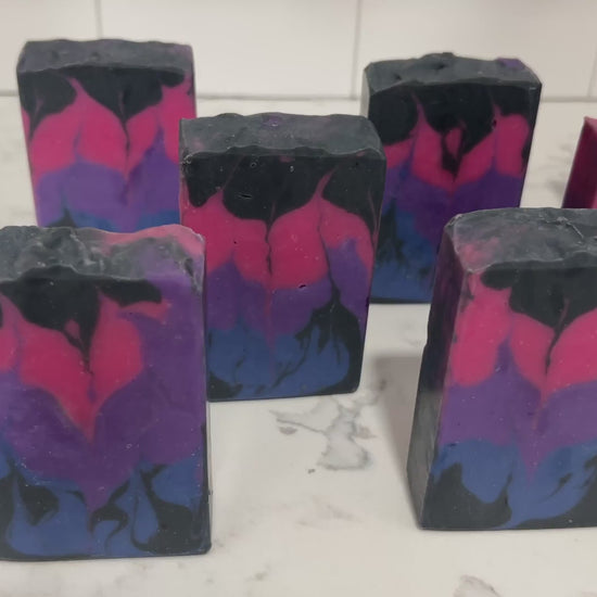 Pink, purple, royal blue, and black bars of soap inspired by the colors of the Bisexual Pride flag, in honor of Pride Month. Proceeds from sales of this soap go to The Trevor Project.