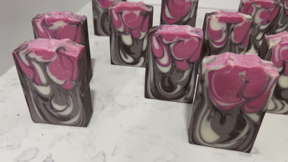 Bars of soap inspired by Jankom Pog from Star Trek: Prodigy. The hot pink, brown, and white bars were created with the drop swirl technique, and smell like rosemary mint.
