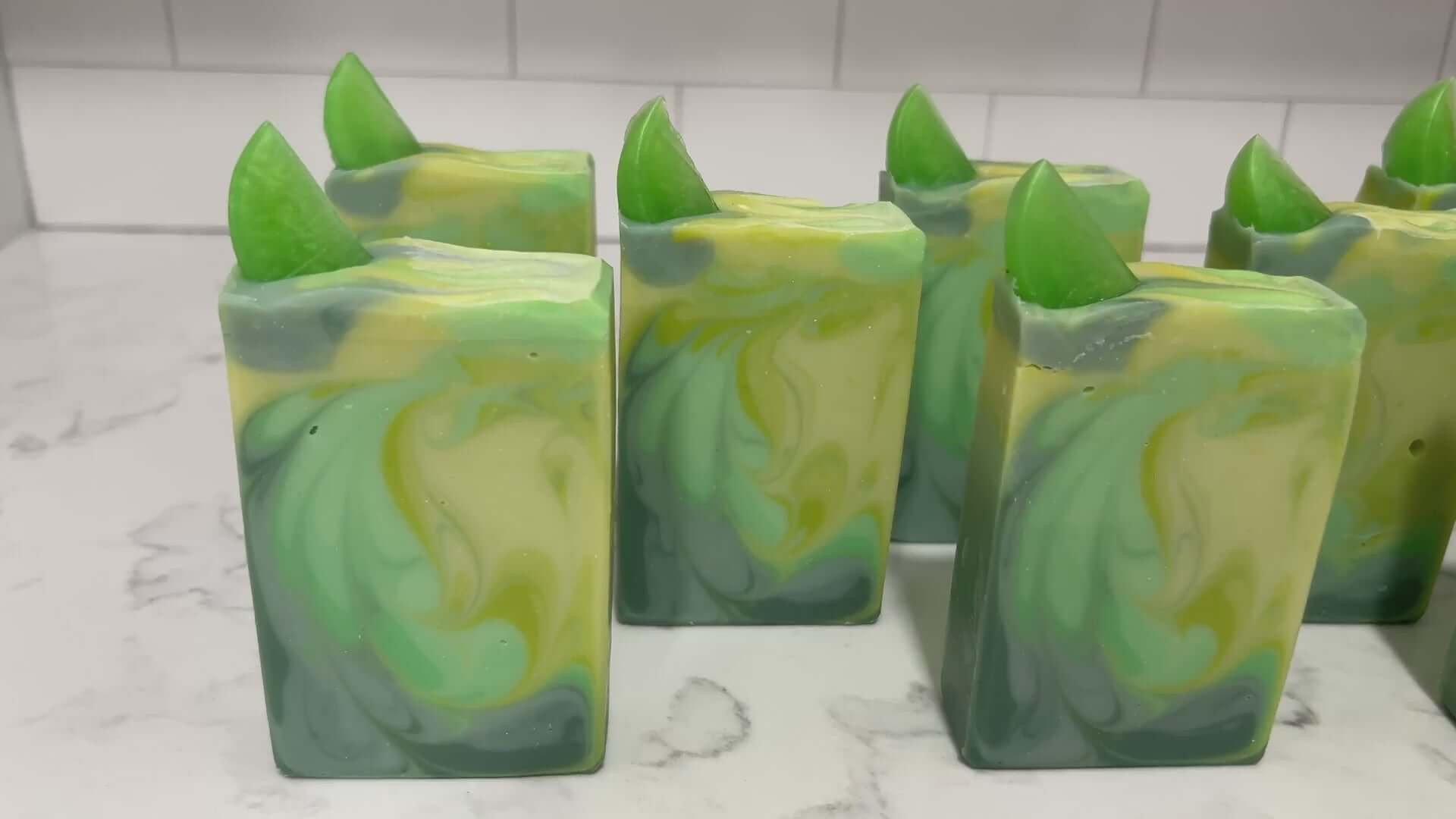 Bars of seven-color green swirled soap made with an intoxicating fresh lime fragrance, and a little lime garnish on top. They are inspired by the Seven of Limes drink mentioned in Star Trek: Discovery.