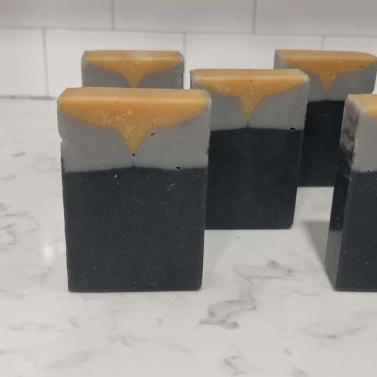 Bars of gold, grey and black soap inspired by the design of the uniforms work on the Star Trek: TNG era uniforms, as well as Deep Space Nine. This soap is scented with a fragrance called Blue Skies, in honor of Data's famous rendition of the song. It smells like clean cotton.