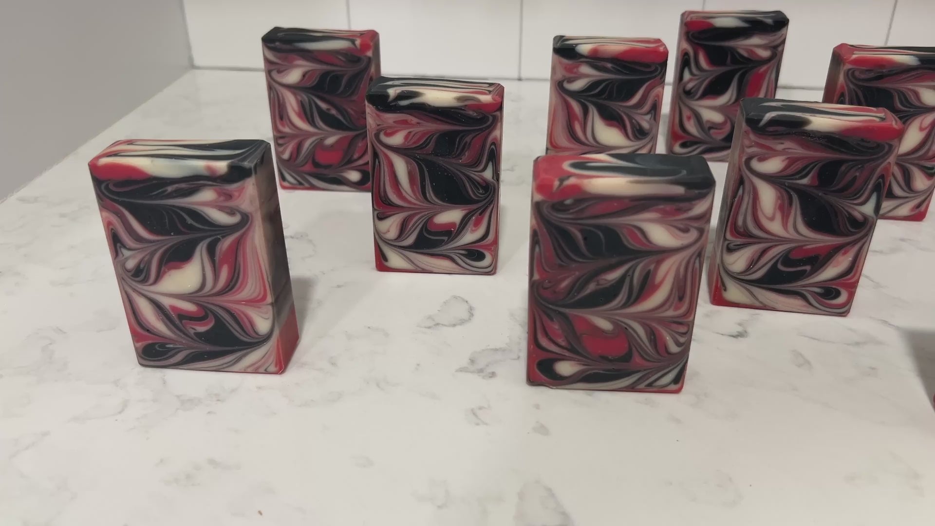Red, black and white swirled bars of soap inspired by Q from Star Trek.