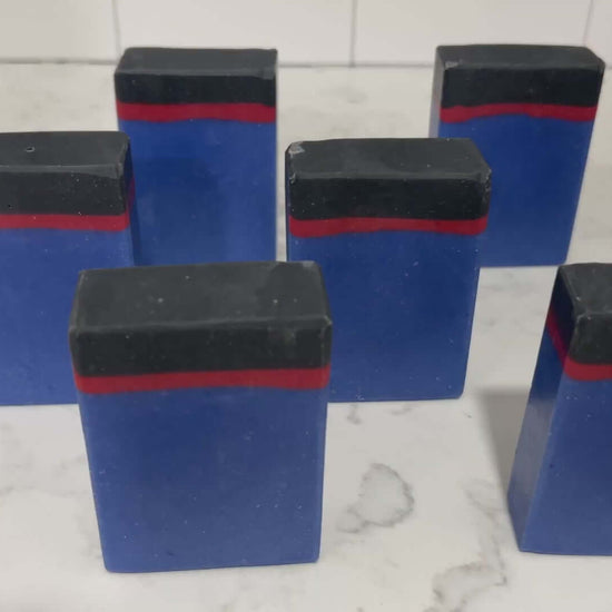 Blue, red and black bars of soap inspired by the uniforms work by the crew on Star Trek: Enterprise. The scent is sea water, a refreshing scent inspired by Jonathan Archer's love for water polo.