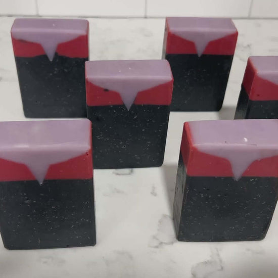 Black, red, and purplish-grey bars of soap inspired by Captain Kathryn Janeway from Star Trek: Voyager. It is scented with an espresso martini fragrance.