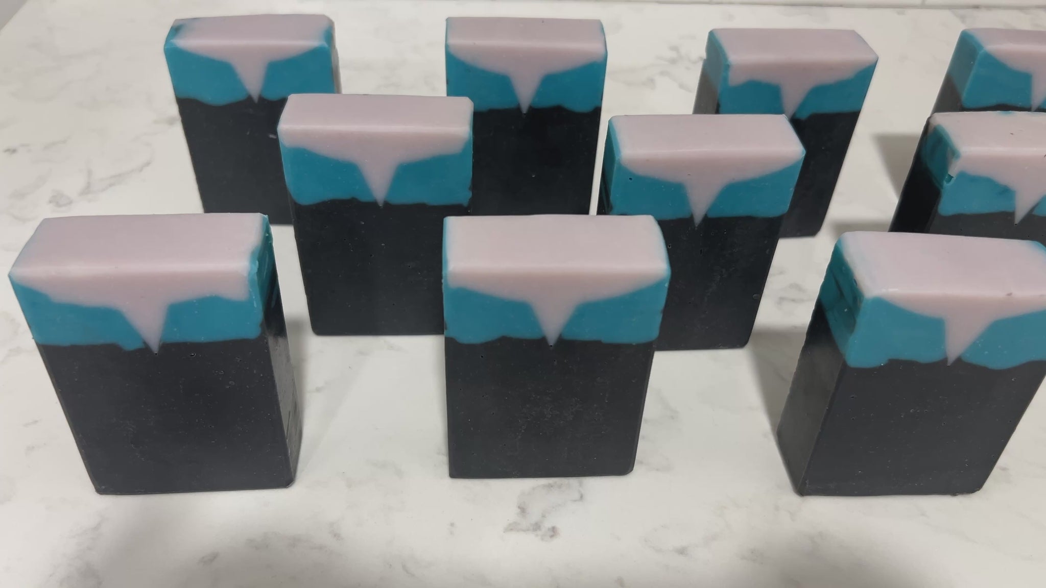 Bars of black, blue, and purplish-grey soap inspired by the look of the uniform worn by Jadzia Dax in the earlier seasons of Star Trek: Deep Space Nine. The scent is cucumber melon.