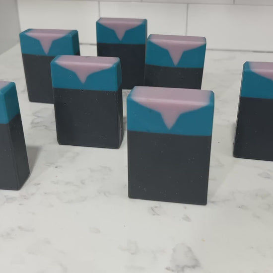 Bars of black, blue, and purplish-grey soap inspired by the look of the uniform worn by Jadzia Dax in the earlier seasons of Star Trek: Deep Space Nine. The scent is cucumber melon.