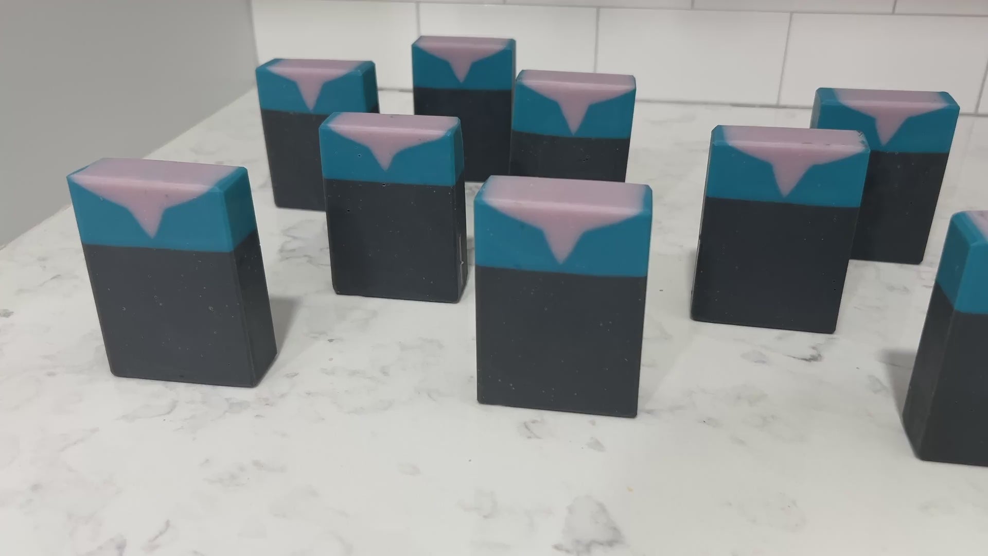 Bars of black, blue, and purplish-grey soap inspired by the look of the uniform worn by Jadzia Dax in the earlier seasons of Star Trek: Deep Space Nine. The scent is cucumber melon.