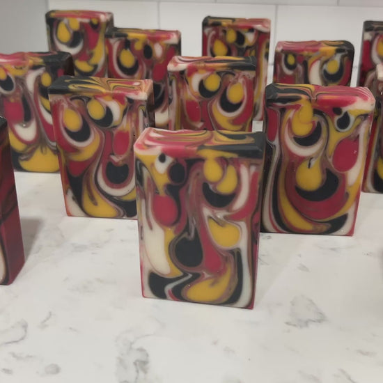Bars of red, white, gold and black drop swirled soap, representing the colors of the Klingon Empire flag. The soap is scented with a blood orange fragrance.