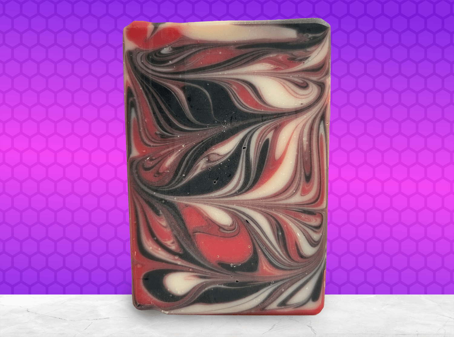 A red, black and white swirled bar of soap inspired by Q from Star Trek.