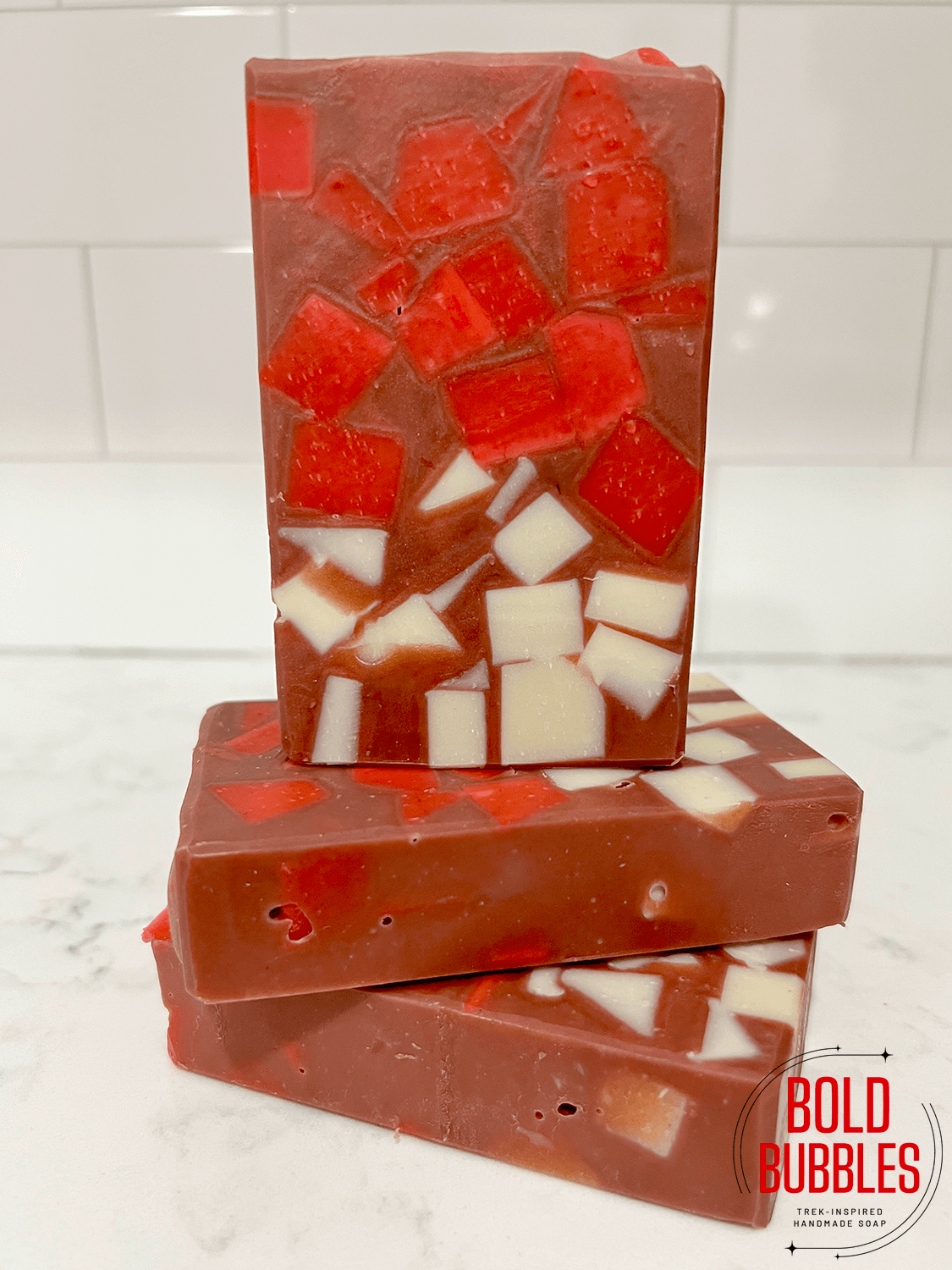 Little cubes of white on bottom, followed by cubes of red soap on top, come together with ruby red soap filling in the gaps to create this soap inspired by Rok-Tahk on Star Trek: Prodigy.