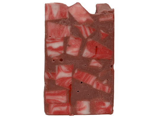 A bar of soap made up of red and white cubes, with brick red filling in the gaps. The soap is inspired by Rok-Tahk, the Brikar, from Star Trek: Prodigy. It smells like red berries and rhubarb.