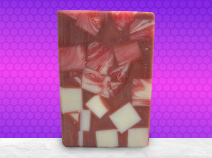 A bar of soap made up of red and white cubes, with brick red filling in the gaps. The soap is inspired by Rok-Tahk, the Brikar, from Star Trek: Prodigy. It smells like red berries and rhubarb.