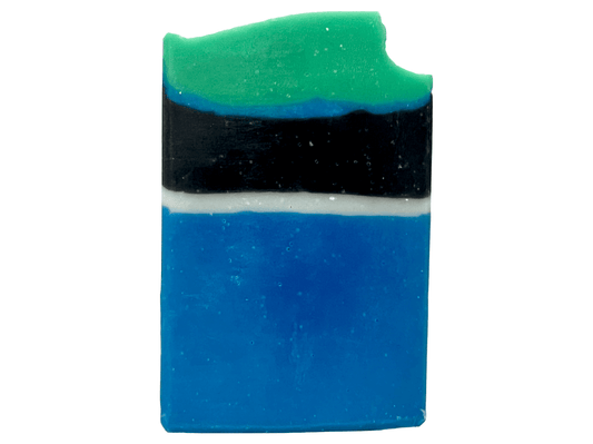 A bar of blue, white, and black soap designed in the Star Trek: Lower Decks-style uniform. At the top is a layer of green for D'Vana Tendi's hair. The scent is eucalyptus mint.