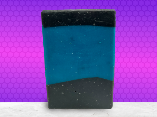 A bar of blue and black soap inspired by the iconic uniforms worn on Star Trek: The Next Generation. The scent is mint frosting, AKA spearmint, in honor of the time Troi became a cellular peptide cake with mint frosting.