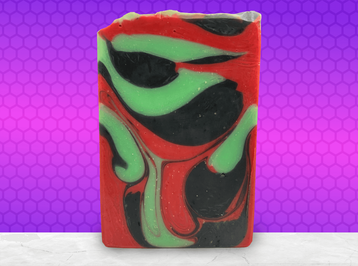 A bar of soap with drop swirls of red, black and green, inspired by the colors of Uhura's uniform and her iconic hoop earrings.